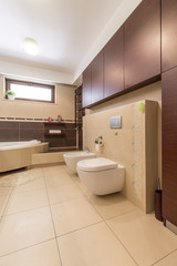 Fototapeta na wymiar Modern bathroom with beige tiles