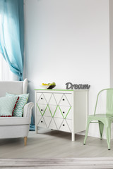 Bright living room with white chest of drawers