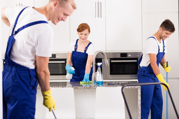 House cleaners cleaning kitchen