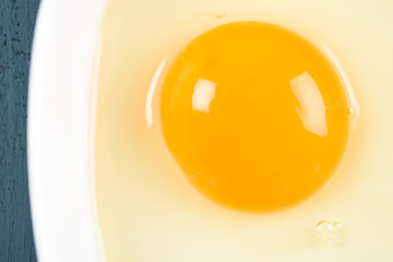Yellow Egg Yolk In White Bowl On Wood Table