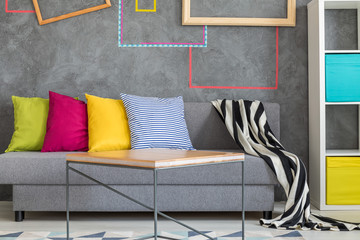Grey sofa with colorful pillows