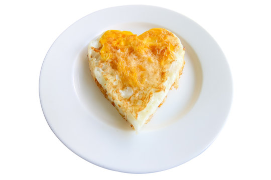 Isolated fried eggs in ideal heart on the white plate on white background