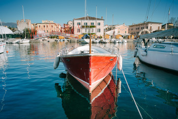 Sailboats and fishing boats at Porto di Bardolino harbor on The Garda Lake . Italy