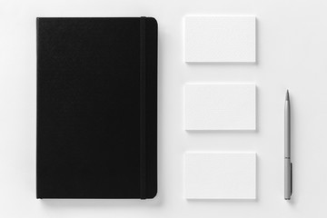 Mockup of business cards and notepad at white textured paper
