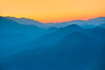 Landscape with blue mountains at sunset
