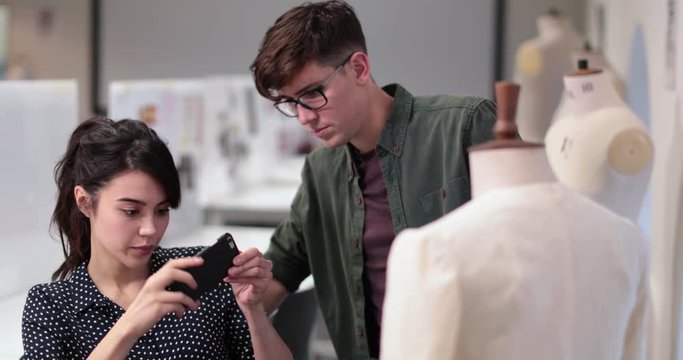 Fashion students taking picture of a design with smartphone