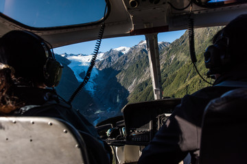 Passengers in a helicopter as it approaches the Franz Josef Glacier in New Zealand