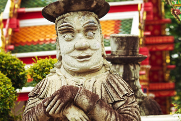 Stone buddhist statue at palace background in Thailand