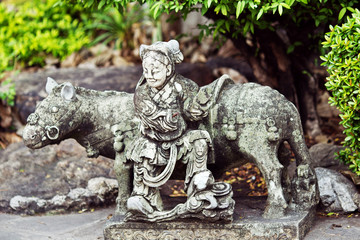 Fototapeta na wymiar Stone statue of woman and horse in Thailand