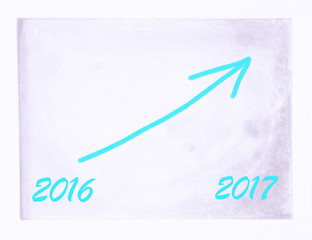 new year 2017 on board with arrow pointing upwards