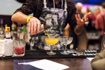 Barman show. Bartender is making cocktail at night club.