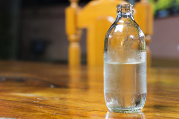 Water bottles on a wooden table.