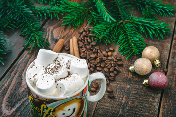 Coffee with cinnamon sticks on christmas background