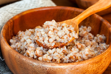 Boiled buckwheat in a wooden bowl, Selective focus