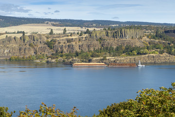 Logging barge on the Columbia River Gorge carrying logs and sawdust. Oregon.