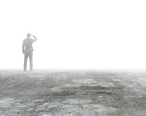 Man gazing and standing in mist on dirty concrete floor