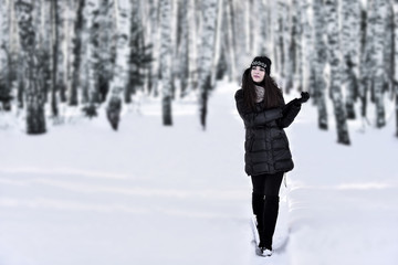 Girl with dark long hair in the winter park
