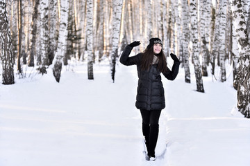 Girl with dark long hair in the winter park