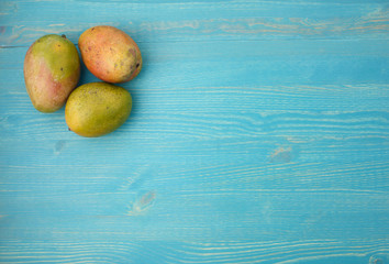 Lot of mango on a blue wooden background