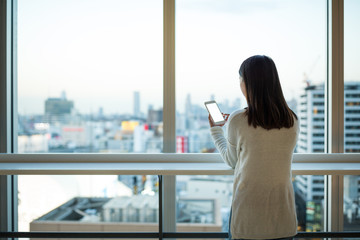 Woman use of cellphone inside office