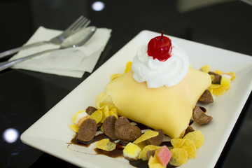 delicious pancake with red cherry and whipped cream on top