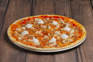 Angle side view of pizza with mushrooms and mayonnaise sause cut