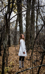 Portrait of a beautiful girl on a background of dry branches