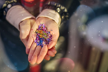 Hands holding bright colours glitter, Holidays background for your content or design, Christmas magic time, Female hands holding coloured confetti, Valentines day mood