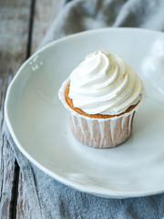 Homemade cupcake on wooden background