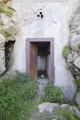 Fototapeta na wymiar Reinforced door - Entry of an old alpine bunker - Vallo Alpino, Italy