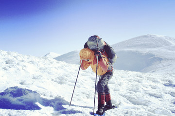 Fototapeta na wymiar Winter hiking in the mountains on snowshoes with a backpack and