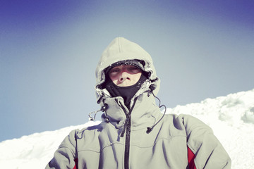 Winter hiking in the mountains on snowshoes with a backpack and