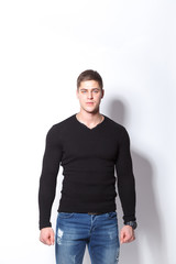 Fototapeta premium Confident and stylish. Cheerful young man looking at camera while standing against white background