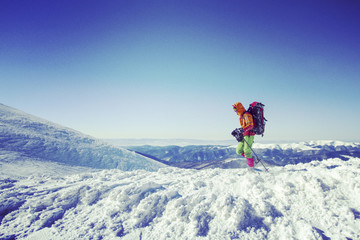 Winter hiking in the mountains on snowshoes with a backpack and