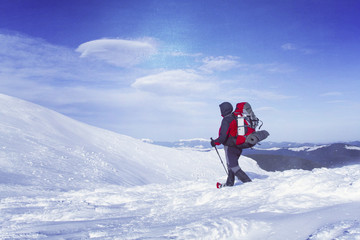 Winter hiking in the mountains on snowshoes with a backpack and