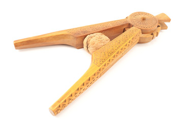 Carved wooden nutcracker with walnut isolated on white