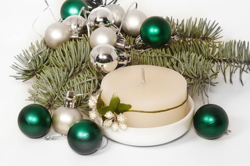 Branch of Christmas tree with white and green balls and white ca