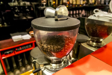 Coffee grinder with coffee beans in the bar