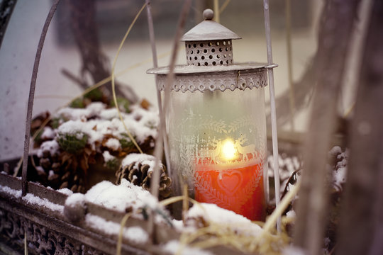 Snow and lantern with candle light.