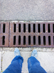 Feet near a metal lattice. 