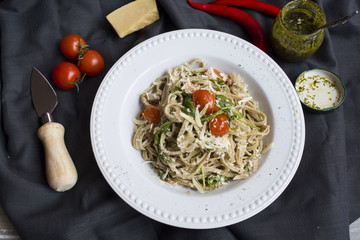Italian vegetarian pasta with tomatoes, cheese and arugula