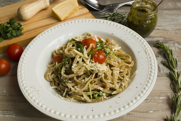 Italian vegetarian pasta with tomatoes, cheese and arugula