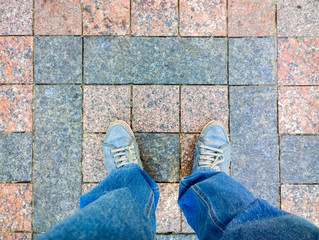 Feet on the cobblestone.