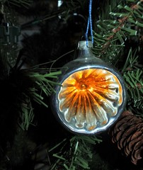 Orange round lantern. vintage christmas toys on new year tree background.