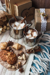 Metal mugs with cacao and marshmallows