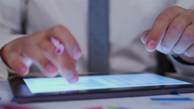 Businessman Analyzing Charts On Digital Tablet Screen