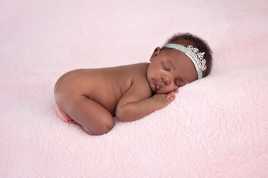 Newborn Baby Girl Wearing A Rhinestone Princess Crown