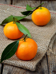 three ripe tangerine on a wooden background. selective focus.