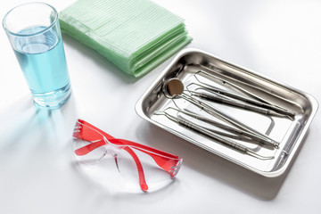 dentists tools in cabinet on white desktop