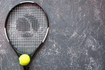 tennis racket on gray background top view